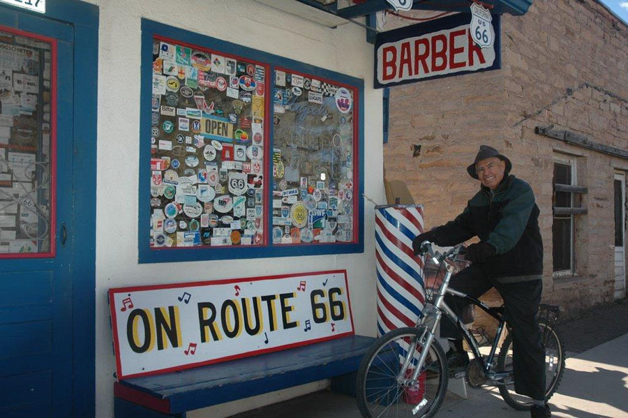 Angel rides his bicycle to his Gift Shop