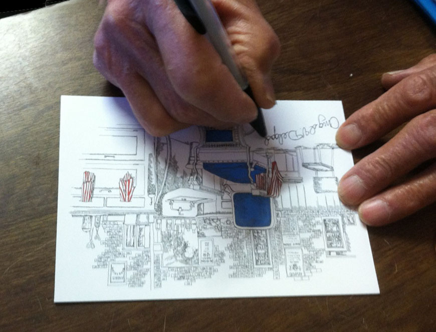 Angel signing one of his note cards