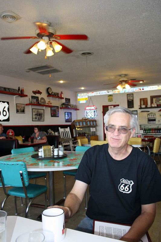 Dennis Purschwitz having a cup of coffee in his Café