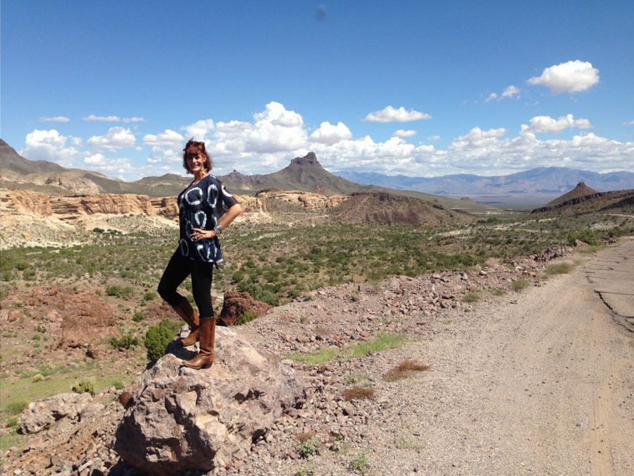 Christine standing by the original Route 66 through the Black Mountains