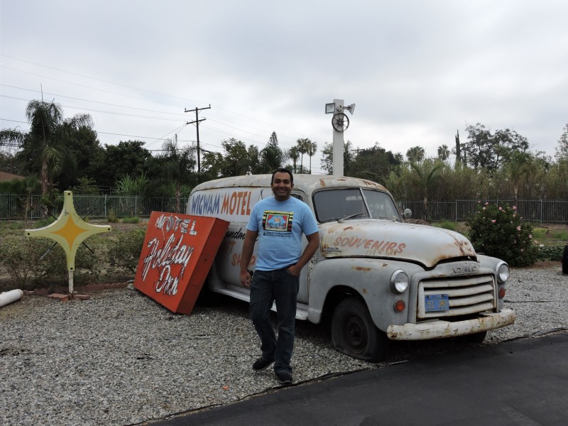 Kumar Patel with antique sign and truck